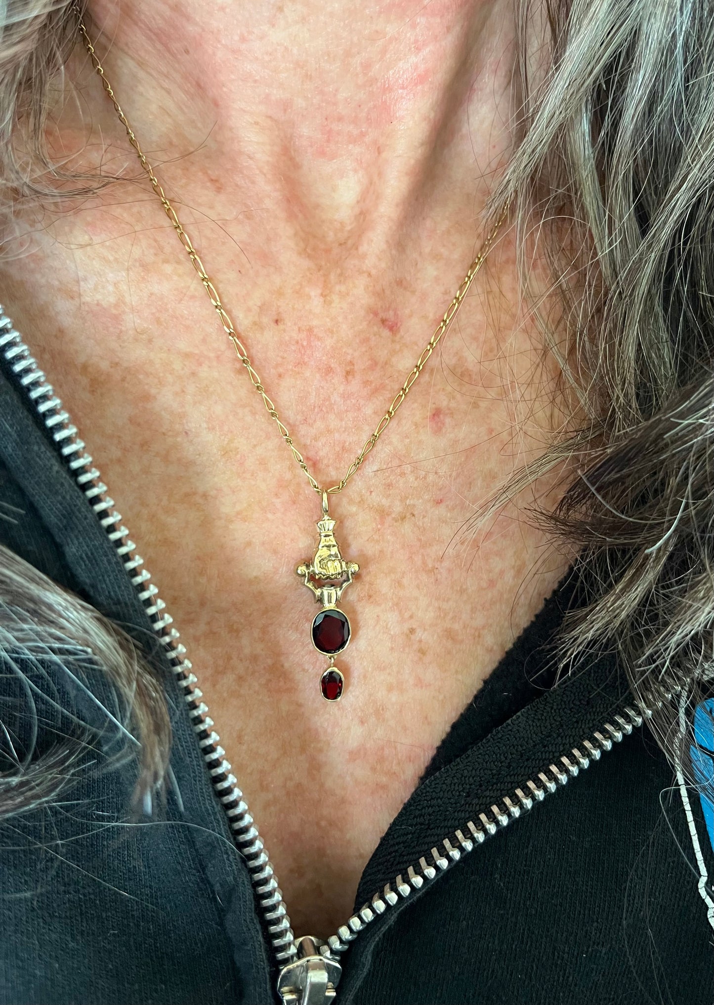Gold Hand and garnet pendant