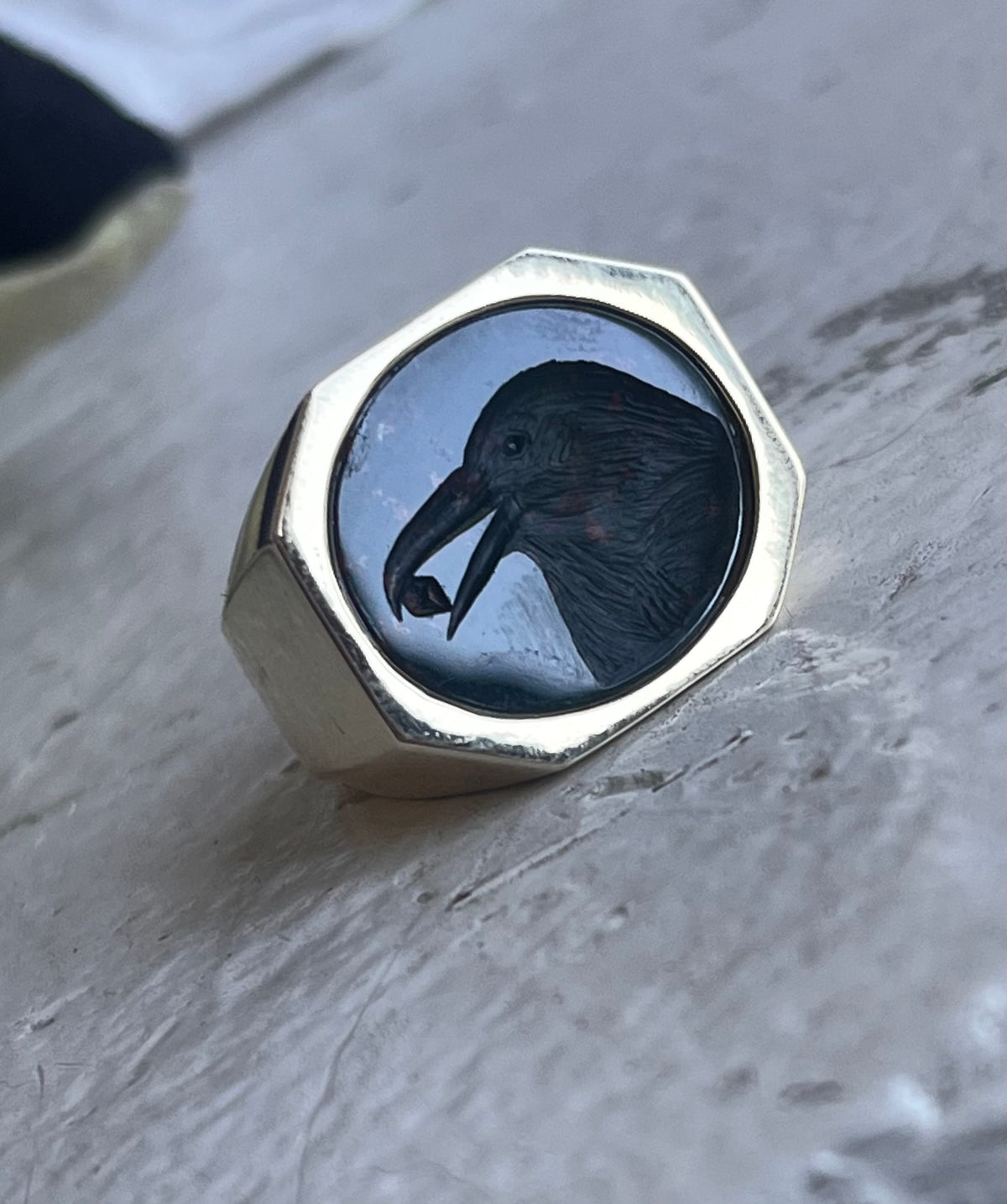 Crow holding a diamond intaglio ring