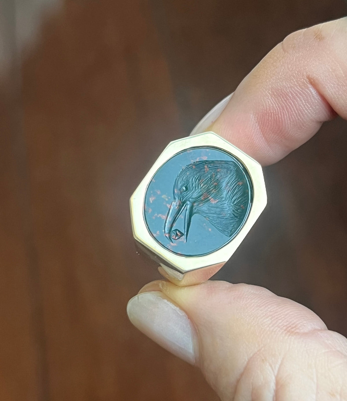 Crow holding a diamond intaglio ring