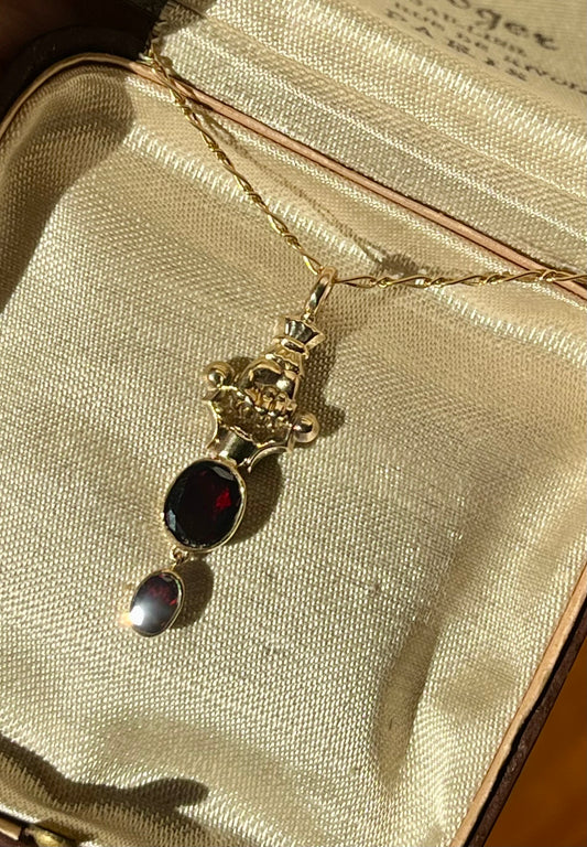 Gold Hand and garnet pendant