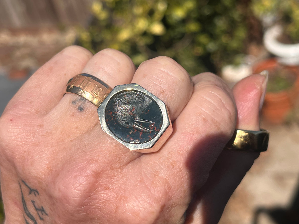 Crow holding a diamond intaglio ring